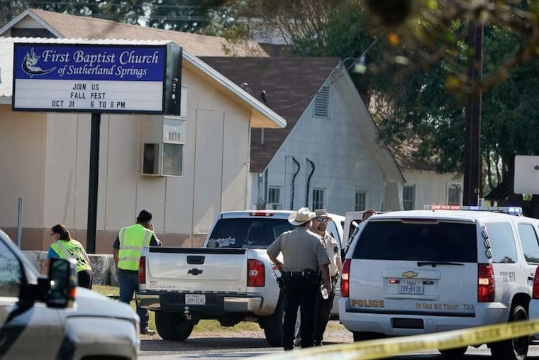 Law enforcement officers gather in front of the First Baptist Church of Sutherland Springs