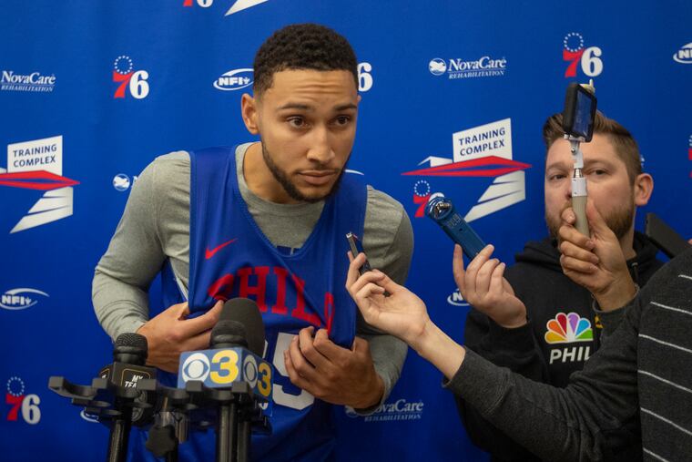 Sixers guard Ben Simmons leans forward to hear a question after Sixers practice at their training facility in Camden on Wednesday.