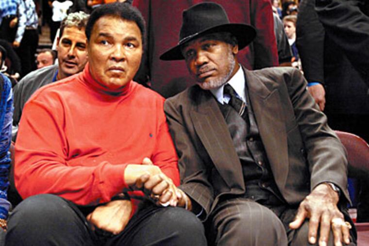 Muhammad Ali and Joe Frazier shake hands at the 2004 NBA All-Star game in Philadelphia. (George Reynolds/Daily News file photo)