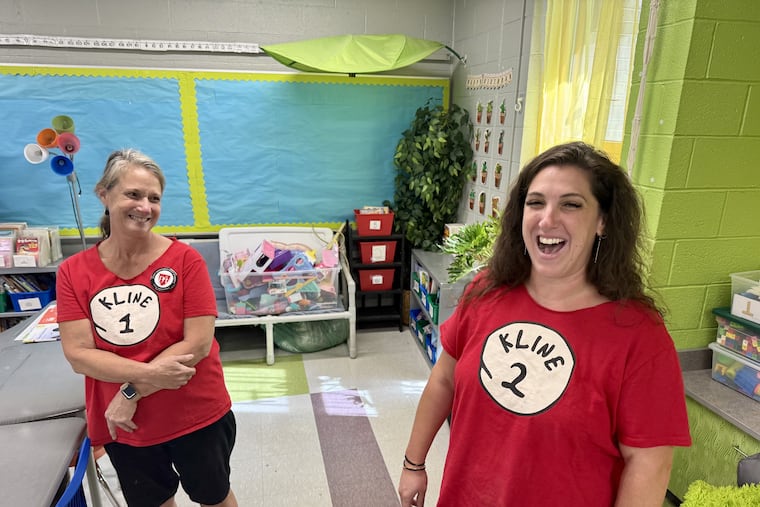 Beth Kline (left) and her daughter Allison Kline share a laugh as they set up their classrooms on Friday. The pair teach third and second grade at Andrew Hamilton Elementary in West Philadelphia.