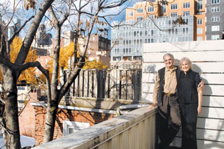 Cecil and Fairley Baker pose on balcony on rear of their South 11th Street home in Washington Square West. (Tom Gralish / Staff Photographer)