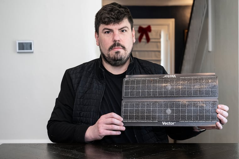 Brendan Nerney shows hundreds of phorid flies on a trap at his home in Avondale, Pa. Phorid flies, associated with mushroom production, are plaguing residents in Chester County who report them invading their homes in large numbers.