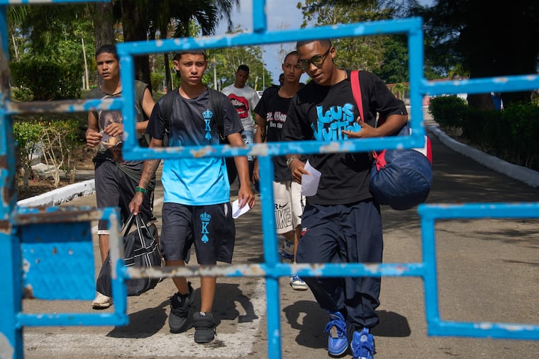 Damian Farinas (right) walks out of La Lima penitentiary alongside other pardoned prisoners after their release in Guanabo, Cuba, on Friday.