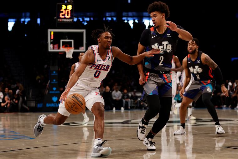 Philadelphia Sixers guard Tyrese Maxey (0) drives to the basket past Brooklyn Nets forward Cameron Johnson during the first half.