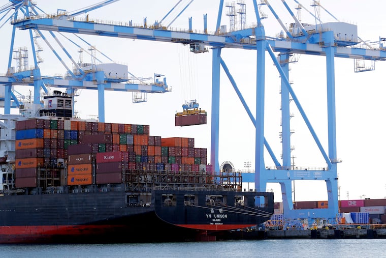 In this Nov. 4, 2019, file photo cargo cranes are used to take containers off of a Yang Ming Marine Transport Corporation boat at the Port of Tacoma in Tacoma, Wash. The U.S. trade deficit surged in July 2020 to $63.6 billion, the highest level in 12 years, as imports jumped by a record amount. The Commerce Department reported, Thursday, Sept. 3 2020, that the July deficit, the gap between what America buys and what it sells to foreigners, was 18.9% higher than the June deficit of $53.5 billion.