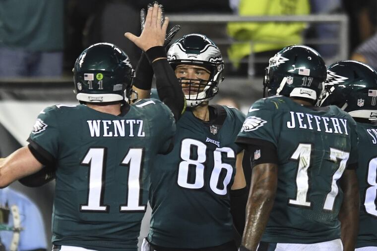 The Eagles tight end Zach Ertz gets a high-five from quarterback Carson Wentz after catching a touchdown pass during the game against the Washington Redskins at Lincoln Financial Field October 23, 2017. Eagles beat Washington 34-24.