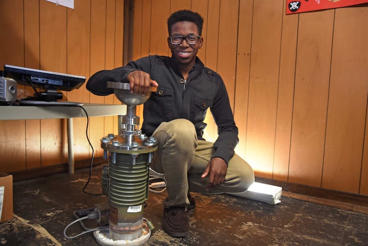 Steven Udotong, 16, poses in the basement workshop of his family's Cinnaminson home where is building a nuclear fusion device.