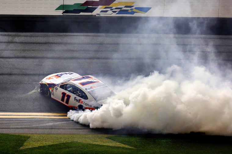 Denny Hamlin (11) smokes his tires after taking the checkered flag at the Daytona 500, at Daytona International Speedway, Sunday, February 17, 2019. (Joe Burbank/Orlando Sentinel/TNS)