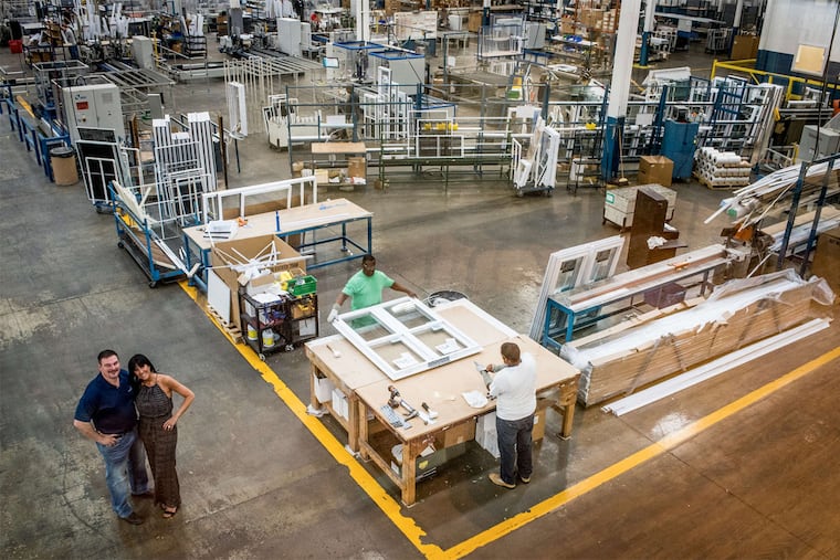 Alan Levin (left), president and CEO of Northeast Building Products, with wife Fran inside the company's warehouse.