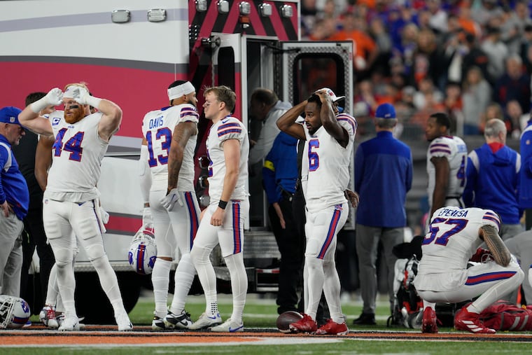 Bills players react as teammate Damar Hamlin is examined on the field on Monday night in Cincinnati.