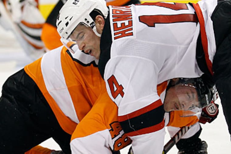 Flyers center Danny Briere gets taken down during a second period face off against the Devils' Adam Henrique. (Yong Kim/Staff Photographer)