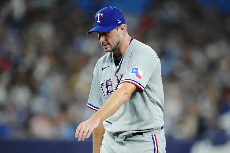 Texas Rangers starter Max Scherzer tries to stretch his arm in a game against Toronto in 2023. Scherzer pitched in only nine games in 2024 because of nerve and shoulder problems.