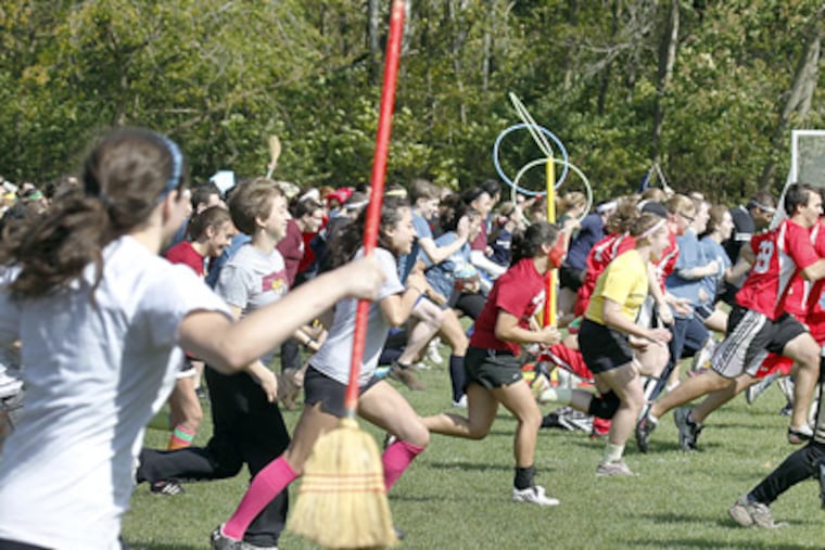 Quidditch tournament players rush to the other end of the field before the game. (Akira Suwa / Staff Photographer)