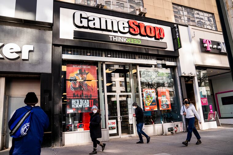 Pedestrians pass a GameStop store on 14th Street at Union Square Jan. 28 in New York.