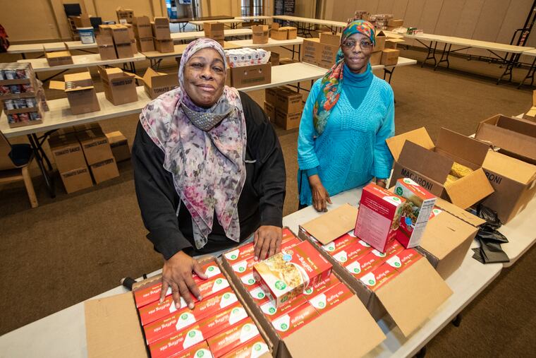 Gaye Nailah Johns, left, and her associate Wajeehah Rashed, right, have been feeding people for 20 years from their food bank at Masjidullah mosque in West Oak Lane.