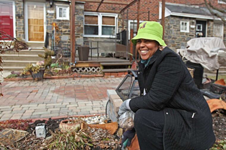 Kim Carter was planting bulbs in her garden and was happy to learn that, under the new assessment plan, taxes on her Country Club Road home would fall by $203 in 2014.