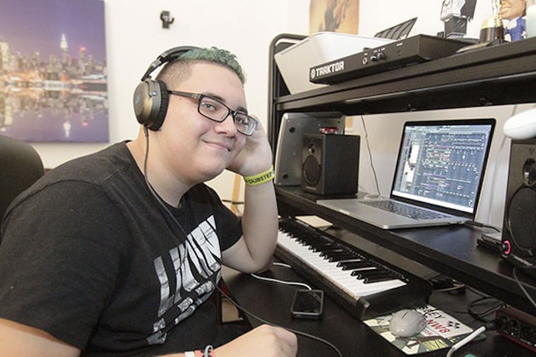 Julian Scanlan listens to his composed music using headphones at his Mt. Laurel home. ( AKIRA SUWA / Staff Photographer )