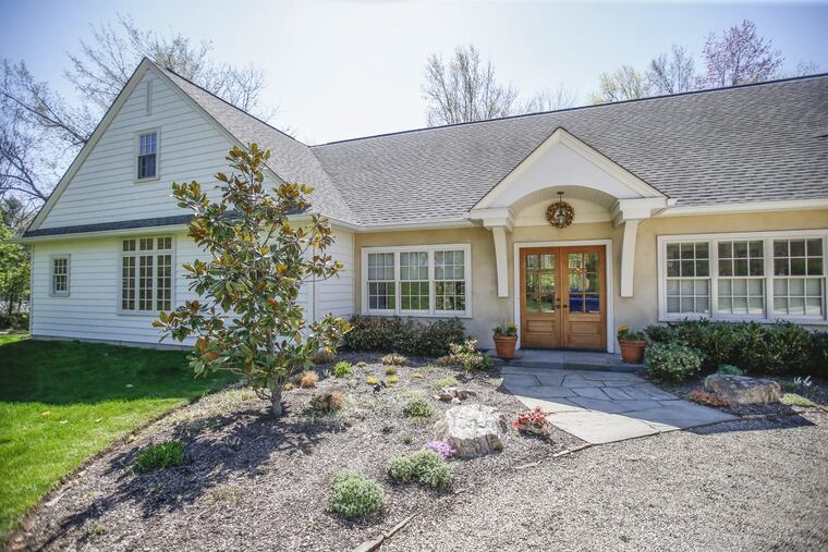 From the outside, Michael and Deborah Anthony’s home in Ambler appears to be a simple ranch style, but grand interior windows unite the indoors with the outdoors.