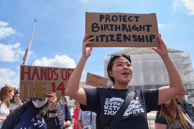 Hannah Liu, 26, of Washington holds up a sign in support of birthright citizenship on May 15, 2025, outside of the Supreme Court in Washington. "This is enshrined in the Constitution. My parents are Chinese immigrants," said Liu. "They came here on temporary visas so I derive my citizenship through birthright."