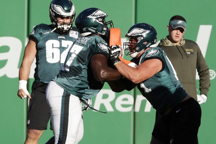 Eagles offensive lineman Stefen Wisniewski (second from right), blocking offensive guard Chance Warmack during practice at Angels Stadium in Anaheim on Thursday.