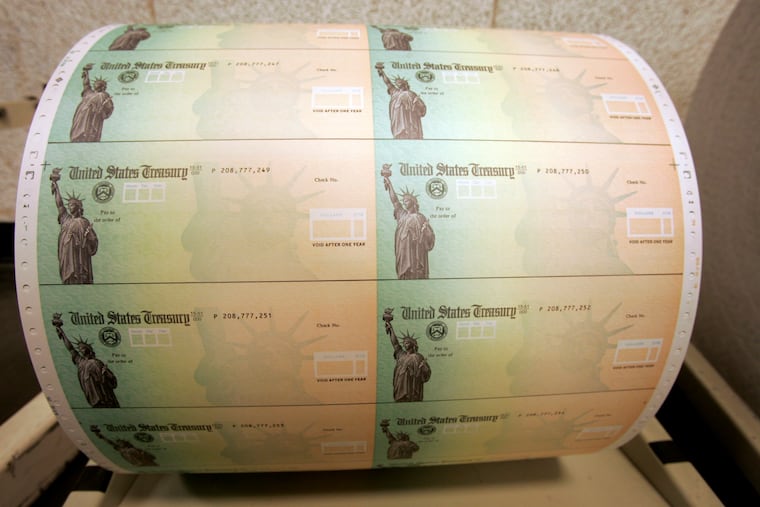 In this, 2008 photo, blank U.S. Treasury checks are seen on a roll at the Philadelphia Financial Center, which disburses payments on behalf of federal agencies, in Philadelphia.