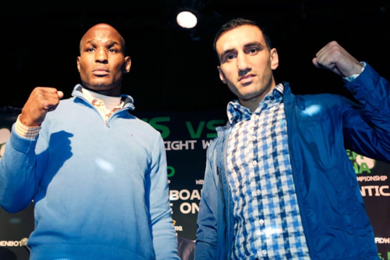 Boxers Bernard Hopkins, left, and challenger Karo Murat of Germany, pose for photographers during a news conference, Wednesday, Oct. 23, 2013, in New York. Hopkins, 48, seeks to become the oldest fighter in history to defend a title when he faces Murat on Saturday in Atlantic City, N.J., for the Hopkins' IBF light heavyweight title. (Kathy Willens/AP)