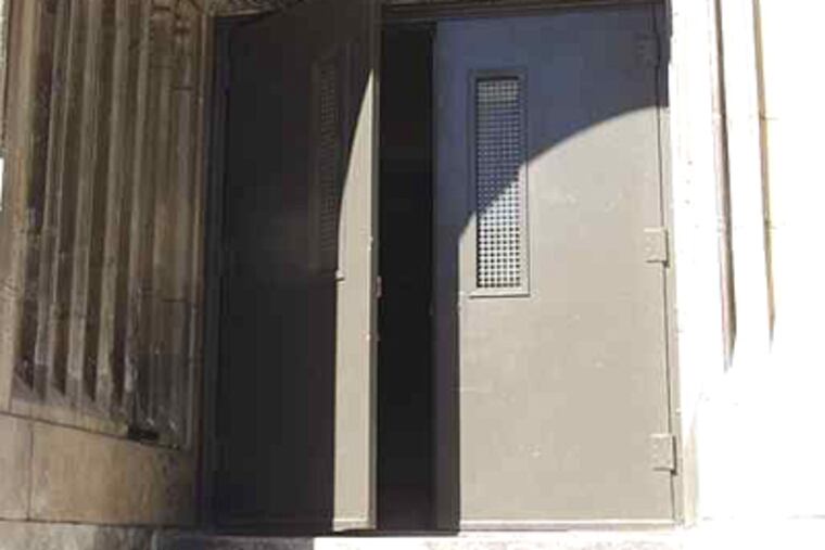 A file photo of an unsecured door at Fitzsimons High. The school is on a new list of persistently dangerous schools. (Inquirer)