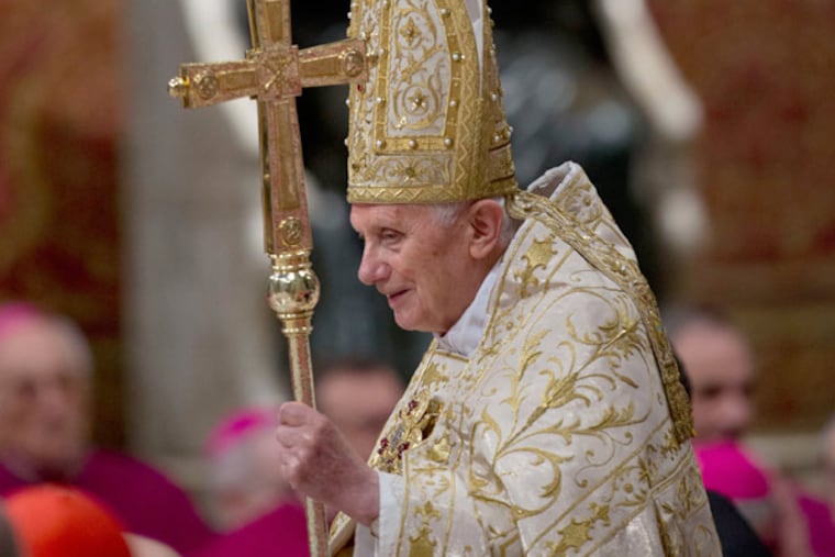 Pope Benedict XVI passes in front of a statue of St. Peter as he arrives in St. Peter's Basilica to celebrate a New Year's Eve vespers service at the Vatican, Monday, Dec. 31, 2012. (AP Photo/Andrew Medichini)