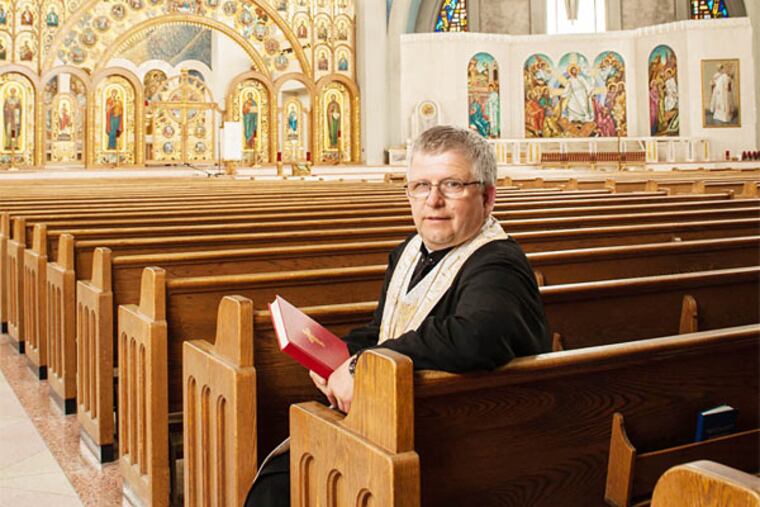 The Rev. Ivan Demkiv inside the ornately decorated cathedral, which draws Ukrainians to the city from throughout the Northeast. (Matthew Hall/Staff Photographer)