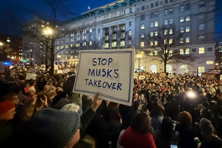 People protest during a rally outside the Treasury Department in Washington on Feb. 4, 2025.