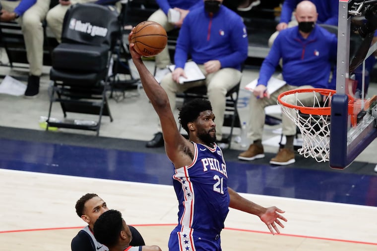 Sixers center Joel Embiid rises for a dunk past Washington Wizards forward Rui Hachimura and center Daniel Gafford in the second quarter of Game 3 of their first-round playoff series in Washington D.C., on Saturday, May 29, 2021.
