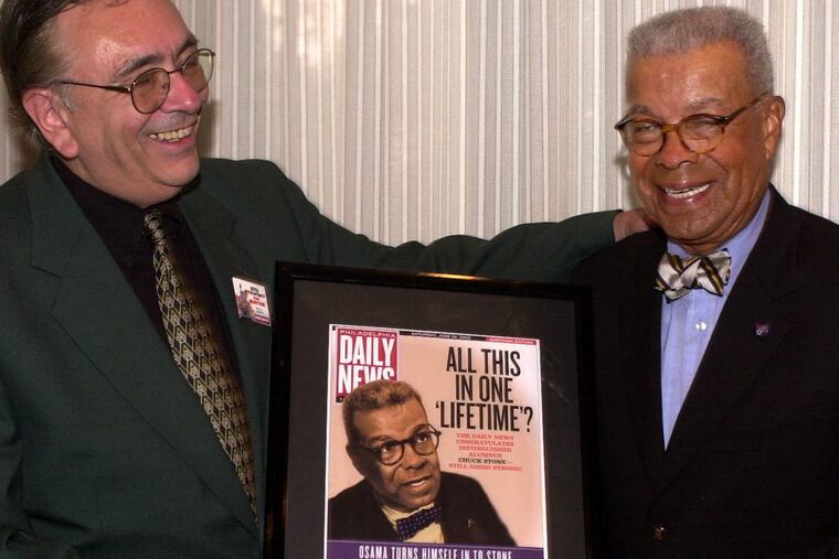 Stu Bykofsky (left) presents a memento to Chuck Stone at a journalism awards dinner in 2002 in Pittsburgh.