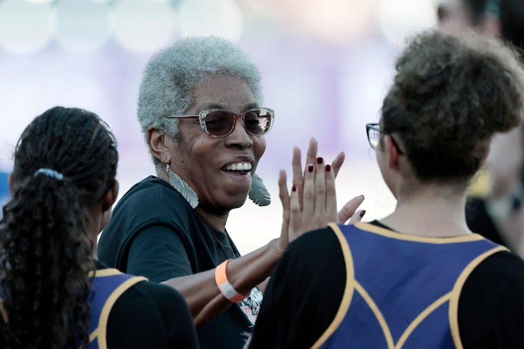 Tina Sloan Green high fives young players after being honored before the inaugural Women's Lacrosse League Championship on Saturday.