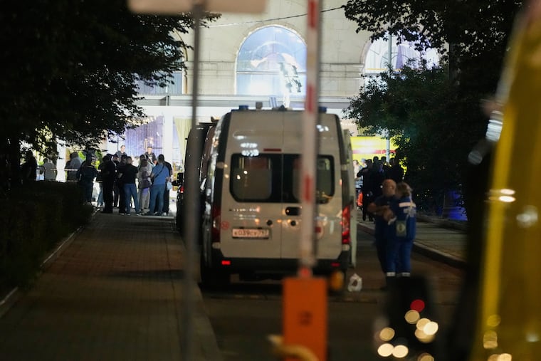 Ambulances and special services vehicles are parked near the site where an improvised explosive device detonated at a restaurant in central Moscow, Saturday, Aug. 1, 2026.