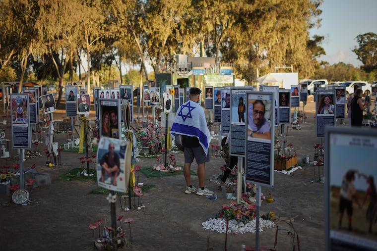 People visit the site of the Nova music festival, where hundreds of revelers were killed and abducted by Hamas and taken into Gaza, as Israel marked the second year anniversary of the attack on Tuesday.