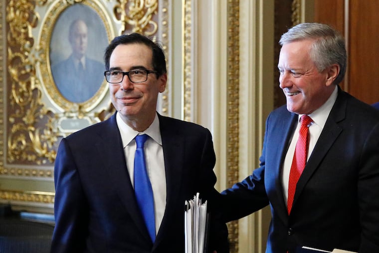 Treasury Secretary Steve Mnuchin, left, and acting White House chief of staff Mark Meadows step out of a meeting on Capitol Hill in Washington on March 25, 2020.
