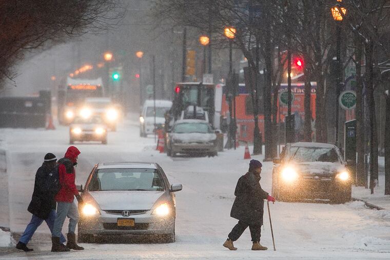 Snow arrives in Philadelphia early Monday, March 3, 2014. Pedestrians make their way along snow covered Chestnut St. at 10th in center city Philadelphia. ( ALEJANDRO A. ALVAREZ / STAFF PHOTOGRAPHER )