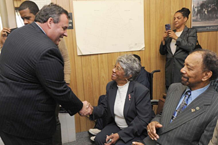 At Chesilhurst Borough Hall, Gov. Christie shakes hands with borough finance clerk Esther Fowler. With her was Councilman Bill Ross. Christie was in the Camden County town Wednesday to get an endorsement for reelection from its Democratic mayor.