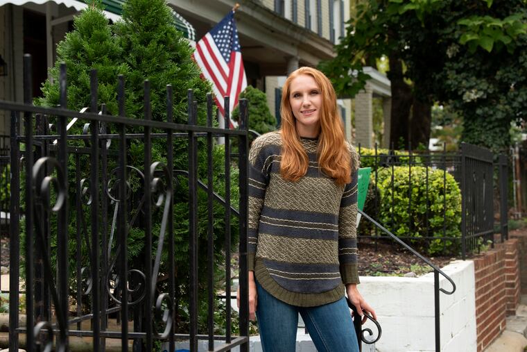 American Airlines flight attendant Allie Malis stands outside her home in Washington. Because so few people are flying, American Airlines is going to lay off 19,000 people unless Congress passes some sort of an airlines relief package or a larger stimulus package.