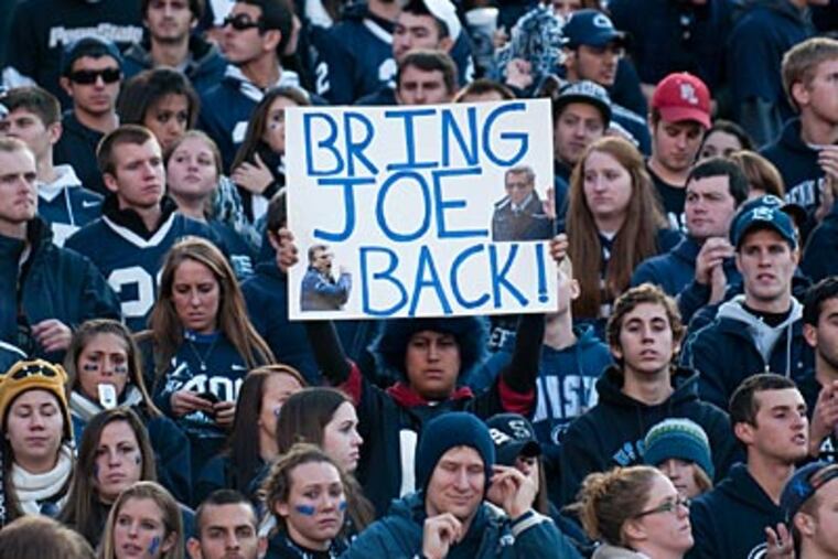 A fan holds up a sign on Saturday calling for the return of Joe Paterno as Penn State's football coach. (Kriston J. Bethel/For the Inquirer)