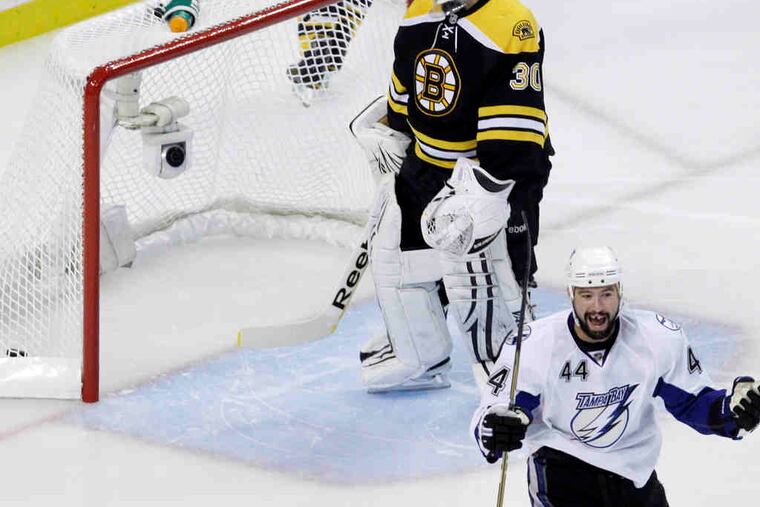 Tampa Bay's Nate Thompson celebrates a goal by Adam Hall 13 seconds into Game 2 of the Eastern Conference finals in Boston. Tim Thomas is the beaten Bruins goaltender.