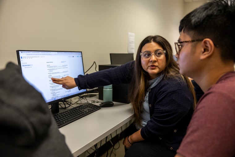 Maria Cabrera, once a student in CCP's TRIO Upward Bound program, now works for it. Here, she helps Anada Seng, 17, a senior at Furness High School, with the college application process.