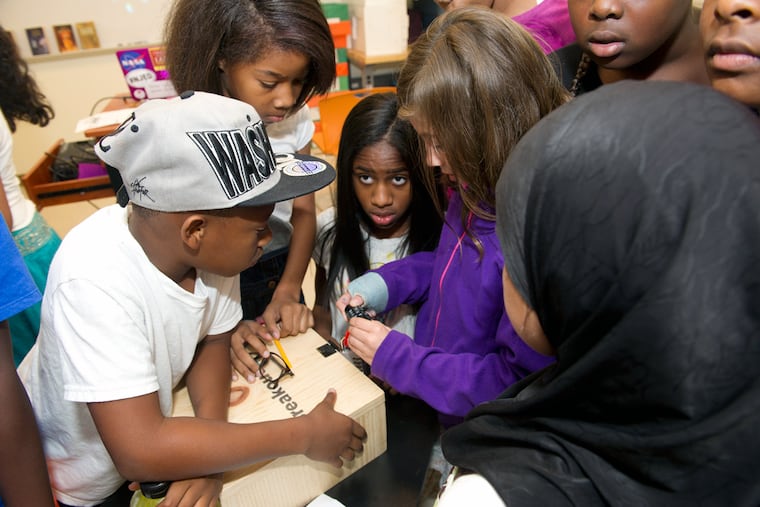 Fifth-graders at Science Leadership Academy Middle School, a new project-based innovative middle school in West Philadelphia, try to figure out the combination to several locks using clues placed throughout the classroom.