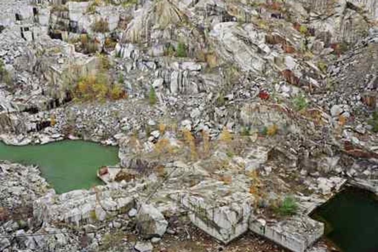In "Rock of Ages #24," the patterns formed by the quarrying of granite blocks simulate cubist abstraction. The photograph is from an Edward Burtynsky exhibition at Ursinus College.