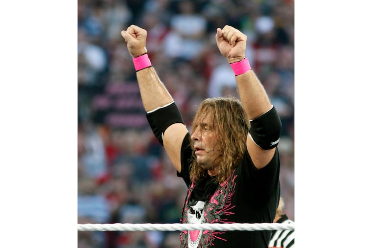 FILE - In this March 28, 2010, file photo, Bret "Hit Man" Hart celebrates his victory over Mr. McMahon at WrestleMania XXVI in Glendale, Ariz. Hart was tackled by a spectator Saturday, April 6, 2019, while he was giving a speech during the WWE Hall of Fame ceremony at Barclays Center. The attacker was promptly subdued by several people, including other wrestlers, who came to Hart's defense. Hart is okay. (AP Photo/Rick Scuteri, File)