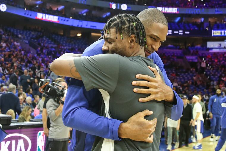 Sixers' Al Horford gets a hug from former teammate Celtics' Marcus Smart before the season home opener at the Wells Fargo Center on Oct. 23.