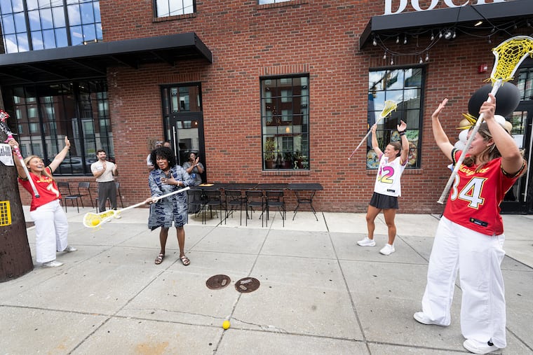 Women's Lacrosse League players Abby Bosco (left), Katie Detwiler, and McKenzie Blake demonstrate a lacrosse drill for Philadelphia Mayor Cherelle L. Parker on Wednesday.
