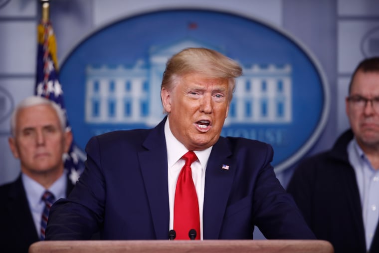President Donald Trump speaks as Vice President Mike Pence (left) and FEMA Administrator Peter Gaynor look on during a coronavirus task force briefing at the White House on Sunday.