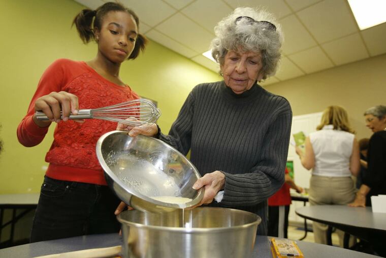 Budding cook Indy Hill, 10, helps volunteer teacher Renee Gelles at Jane Addams Place.