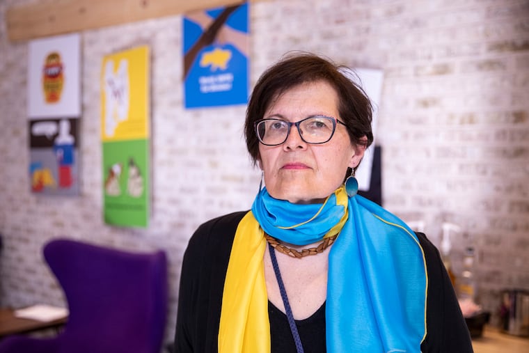 Mary Kalyna, a Ukrainian American activist, poses inside the Wilma Theater, where Poster Art for Ukraine is displayed.